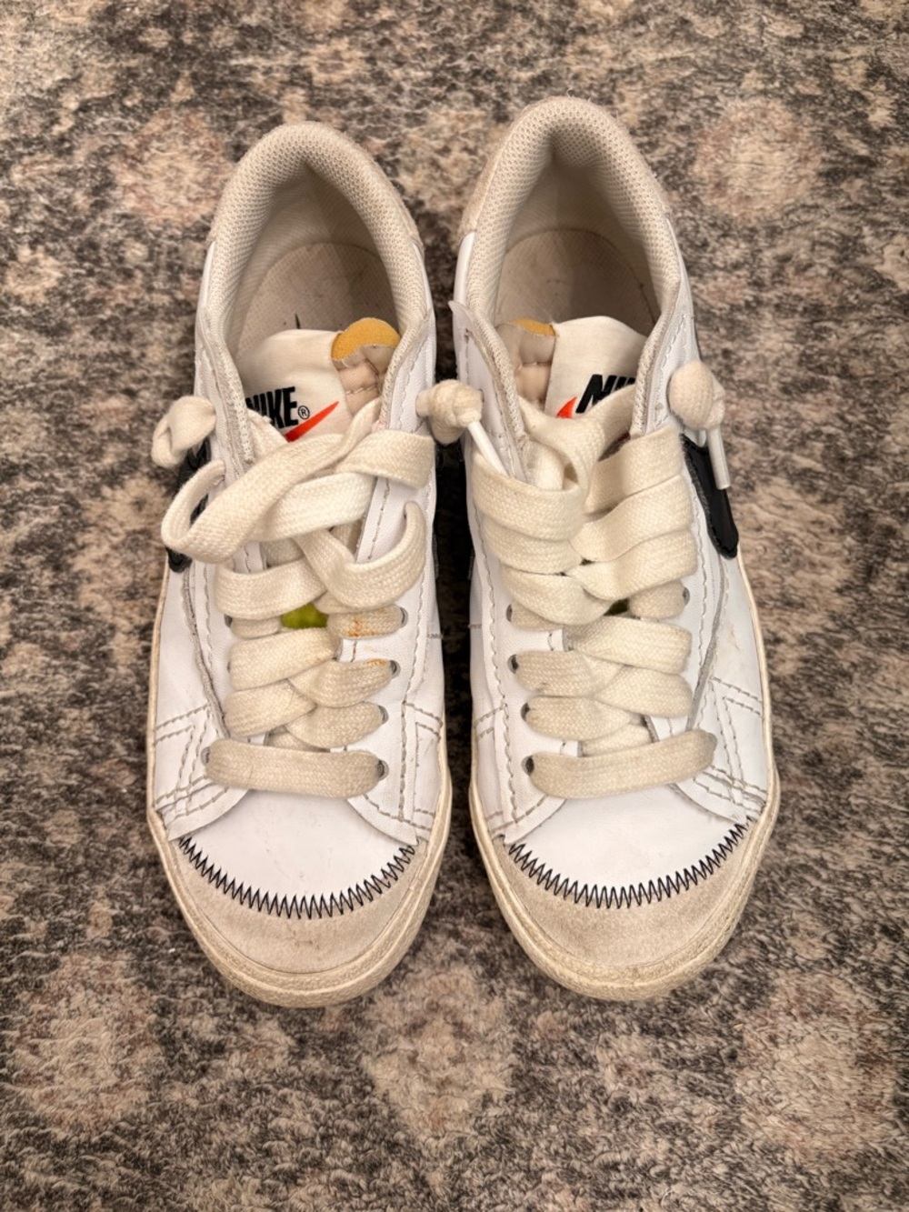 Nike White Low-Top Sneakers with Black Swoosh and Yellow Tongue Detail